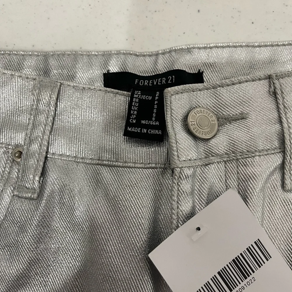 Forever 21 Silver faux leather raw hem mini skirt size small with 5 pockets.